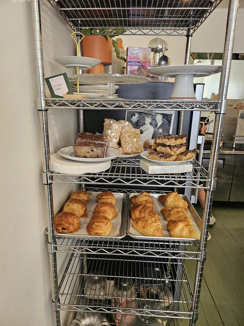A rack of croissants and baked goods
